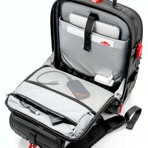 The KNIPEX Modular X18 backpack opened fully flat, showing the two main compartments, 37 pockets, and removable tool board.
