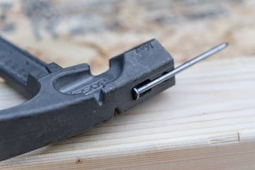 The MAG START magnetic nail slot on the Boss Hammer Pro Plus, securely holding a large duplex nail before striking.