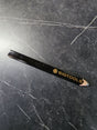 Close-up shot showing the dark graphite lead of a sharpened SIGTOOLS pencil ready for drafting.